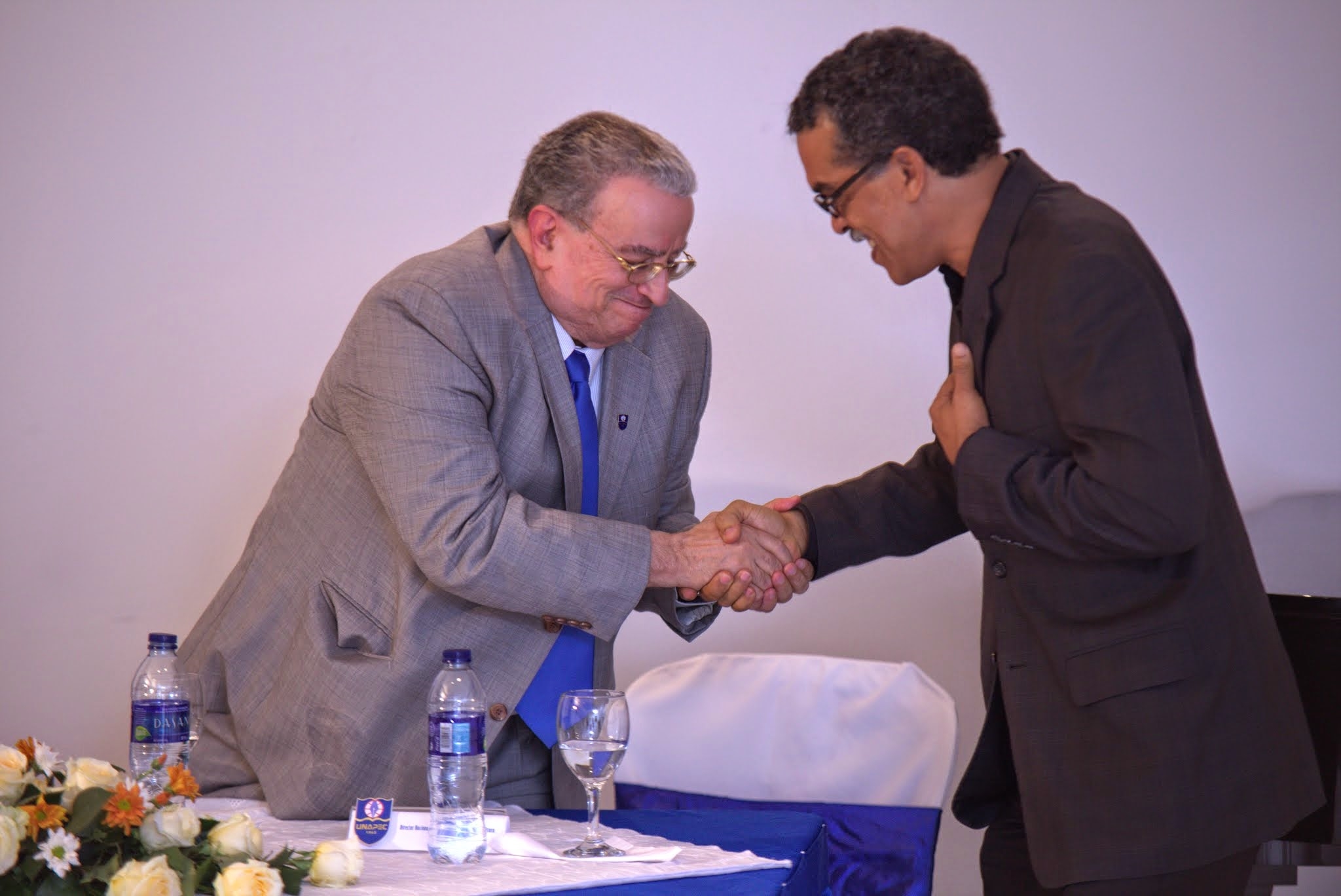 Radhamés Mejía, rector de UNAPEC felicita a Edis Sánchez por la puesta en circulación de su libro.