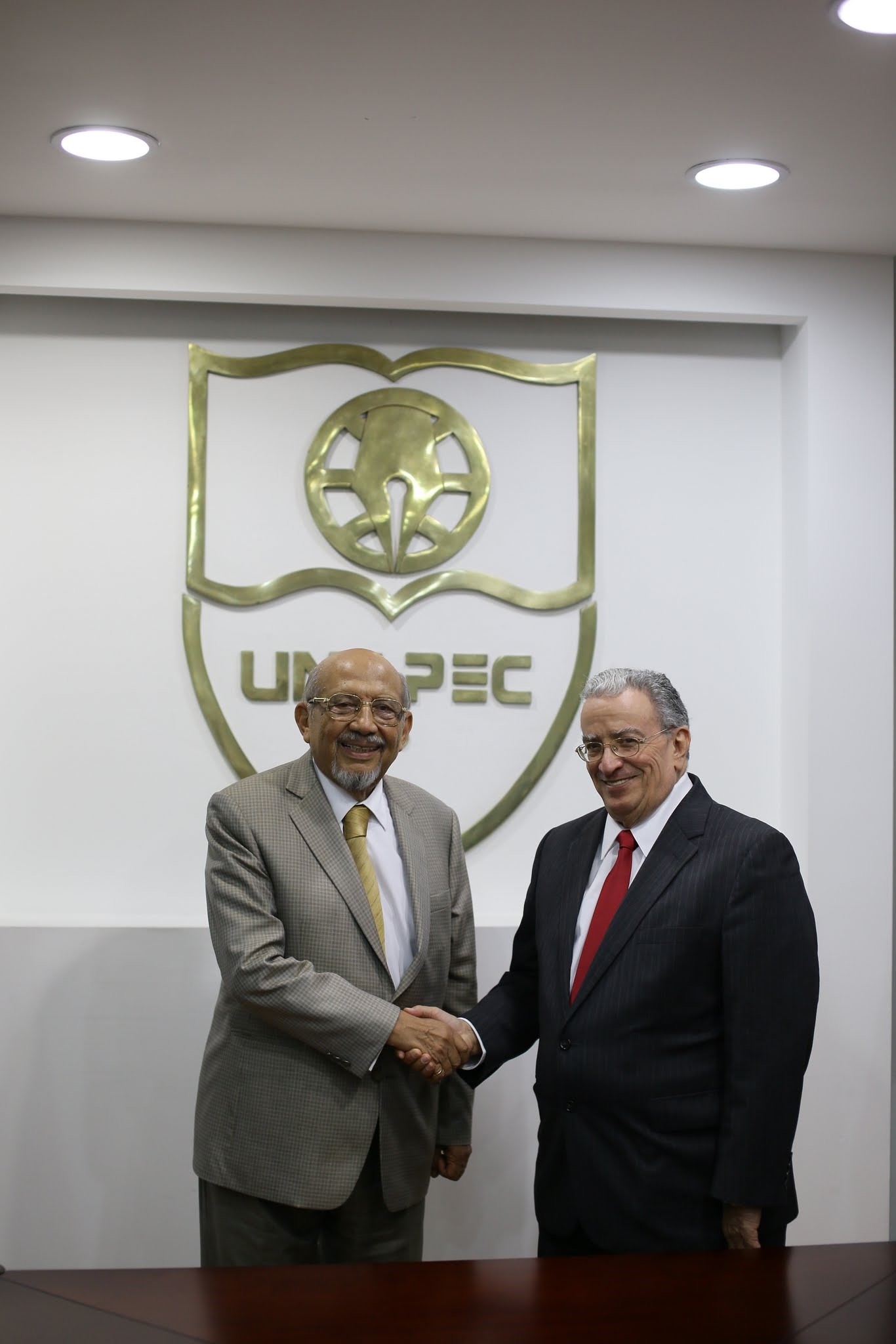 entre Luis H. Pérez representante de la Universidad Autónoma de Occidente (UAO) y el doctor Radhamés Mejía Tejeda, rector de UNAPEC